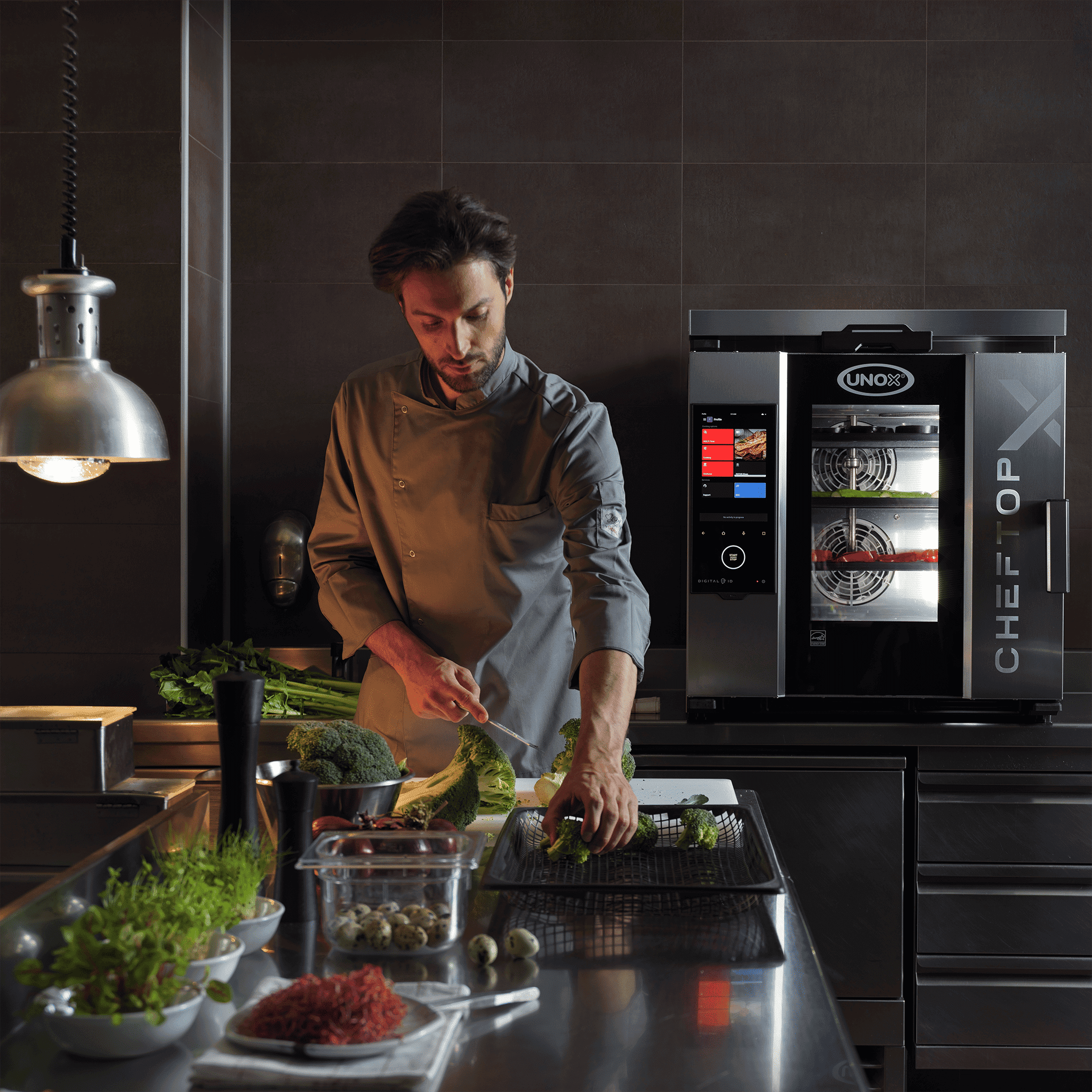 chef cooking with cheftop-x commercial combi oven in background